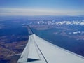 Aerial view scene from the left wingside of aeroplane flying in sunny day with blue sky Royalty Free Stock Photo