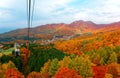 Aerial view of a scenic cable car flying over the beautiful autumn valley of Zao, a famous resort for skiing and Onsen  hot sprin Royalty Free Stock Photo