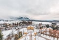 Aerial view of Schloss Hellbrunn covered in snow with view of Untersberg near Salzburg Outskirts in winter time