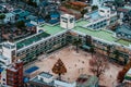 Aerial view school buildings in residential area of Ichikawa district with football field. Tokyo - Japan