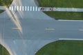 Aerial view of schoolchildren waiting for school bus to arrive. Kids standing on town street side ready to be picked up Royalty Free Stock Photo