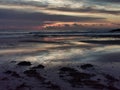 Aerial view of the sea, beach boulders and waves at sunset. Waves crashing on sandy beach Royalty Free Stock Photo