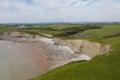 Aerial view of sea cliffs, rock formations and a sandy beach Southerndown, Wales, UK