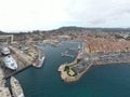 Aerial view of sea dry dock in La Ciotat city, France, the cargo crane, boats on repair, a luxury sail yacht and motor