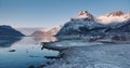 Aerial view of sea shore, snowy mountains, rorbuer at sunset