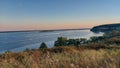 Aerial view of sea waves breaking greenery beach during sunset Royalty Free Stock Photo