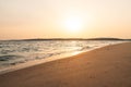 Aerial view of sea waves breaking sandy beach during sunset Royalty Free Stock Photo