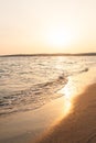 Aerial view of sea waves breaking sandy beach during sunset Royalty Free Stock Photo