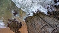 Aerial view of sea waves crashing on rocks cliff in the blue ocean. Top view of coastal rocks in Phuket ocean. Landscape view Royalty Free Stock Photo