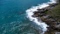 Aerial view of sea waves crashing on rocks cliff in the blue ocean. Top view of coastal rocks in Phuket ocean. Landscape view Royalty Free Stock Photo