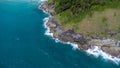 Aerial view of sea waves crashing on rocks cliff in the blue ocean. Top view of coastal rocks in Phuket ocean. Landscape view Royalty Free Stock Photo