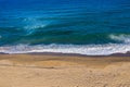 Aerial view of sea waves and a remote secluded sandy beach Royalty Free Stock Photo