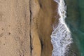 Aerial view of sea waves and a remote secluded sandy beach