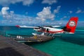 Aerial view of a tropical island in the Indian ocean with seaplane approaching, Maldives Royalty Free Stock Photo