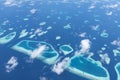 Aerial View from seaplane window over Atolls at Indian Ocean Maldives