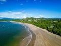 Aerial view of a secluded sandy beach surrounded by clear blue ocean waters.