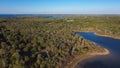 Aerial view a secondary point or hump surrounding by lush green trees and curved sandy shoreline at Isle du Bois Ray Roberts Lake