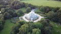 Aerial view of the Sefton Park Palm House in Liverpool, Merseyside surrounded by lush greenery