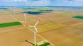 Aerial view of several windmills, wind generators, turbines, producing renewable clean energy by converting kinetic energy Royalty Free Stock Photo