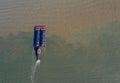 Aerial view of a ship by garbage barrel in the shallow water Royalty Free Stock Photo