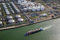 Aerial view of a ship pasing an oil storage silo terminal port Royalty Free Stock Photo