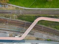 Aerial view shot by a drone of a cyclists and pedestrian bridge over the railroad tracks Royalty Free Stock Photo