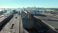 An aerial view of silos in the North Vancouver cargo terminal and trainyard with a view of downtown Vancouver.