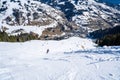 Aerial view of the skiers in a mountainous ski resort in the alps