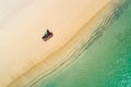 Aerial view of slim woman sunbathing lying on a beach chairin Seychelles. Summer seascape with girl, beautiful waves, colorful