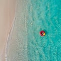 Aerial view of slim woman swimming on the swim ring donut in the transparent turquoise sea in Seychelles. Summer seascape with Royalty Free Stock Photo