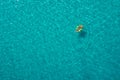 Aerial view of slim woman swimming on the swim ring  donut in the transparent turquoise sea in Seychelles. Summer seascape with Royalty Free Stock Photo