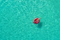 Aerial view of slim woman swimming on the swim ring in the trans