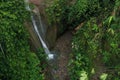Aerial View Of A Small Cascade Surrounded By Lush, Green Foliage In A Tropical Rainforest