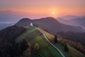 Aerial view of small church on the mountain over low clouds Royalty Free Stock Photo