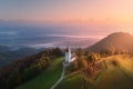 Aerial view of small church on the mountain over low clouds Royalty Free Stock Photo