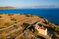 Aerial view of a small church next to a blue ocean on a hot Greek island Royalty Free Stock Photo