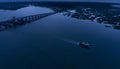 Aerial view of a small commercial ship going past the small town of Beaufort, South Carolina at night