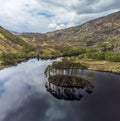 An aerial view the small forested island and eastern shore of Loch Eilt, Scotland Royalty Free Stock Photo