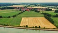 Aerial view of a small German village behind a canal in the flat area, Northern Germany with pastures and arable land Royalty Free Stock Photo