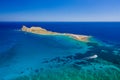 Aerial view of a small island and boats in a crystal clear blue ocean Royalty Free Stock Photo