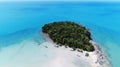 AERIAL view of small isolated tropical island with white sandy beach and blue transparent water and coral reefs. Top Royalty Free Stock Photo