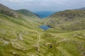 Aerial view of a small lake in a rugged mountain pass