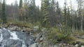 Aerial view of a small mountain river with big stones. Clip. Picturesque natural landscape, spring or autumn view of Royalty Free Stock Photo