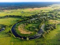 Aerial view of small oxbow lake with trees