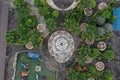 Aerial view of a small public park in the tropics showing the fountain, part of a playing ground and the many floral patterns