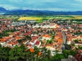 Aerial view of the small Romanian town of Rasnov in the Carpathian valley. Beautiful panorama of the village with red roofs on the Royalty Free Stock Photo