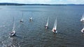 Aerial view of small sailing boats gliding in the river in the summertime. Video. Concept of summer sport, people
