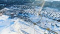 Aerial view of small village among the fields and forests in winter. Journey. Winter picturesque landscape, snow covered Royalty Free Stock Photo