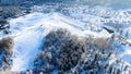 Aerial view of small village among the fields and forests in winter. Journey. Winter picturesque landscape, snow covered Royalty Free Stock Photo
