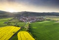 Aerial view of small village with houses placed in green valley with mountain at dramatic sunset, Slovakia Royalty Free Stock Photo